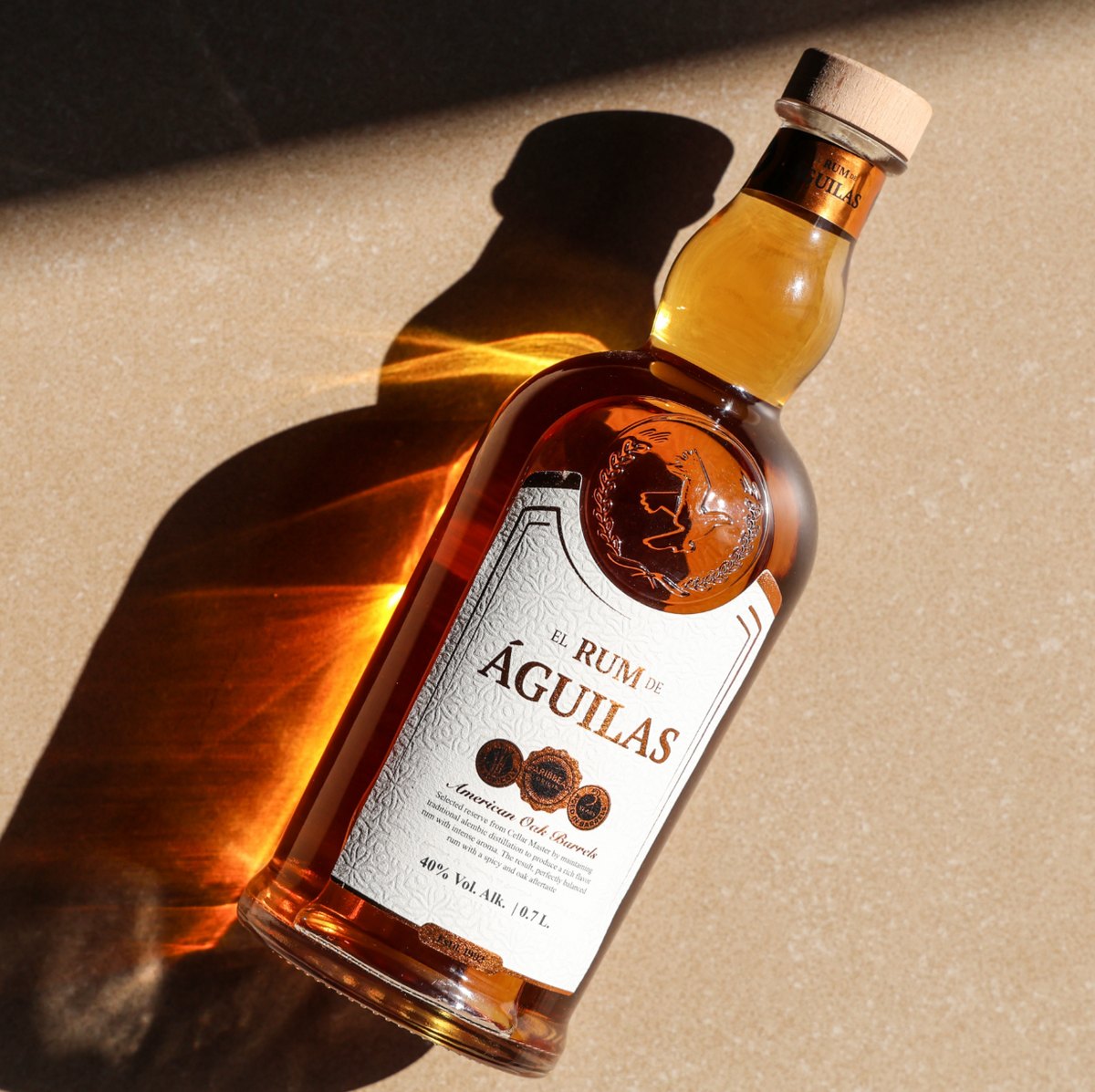 El Rum de Águilas bottle resting in warm light