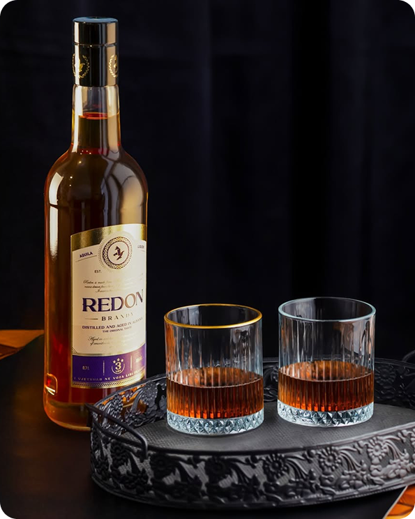 Redon brandy poured beside two glasses
